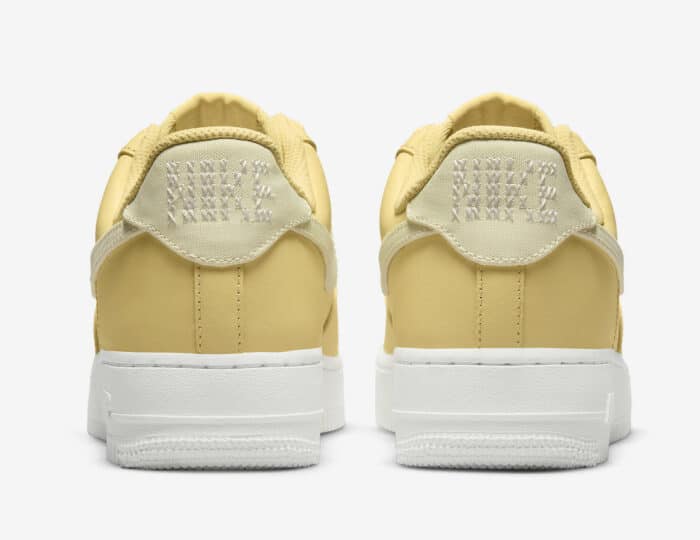yellow air force 1 with crosstitching the Nike brand